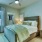 a bedroom with a bed and a fan