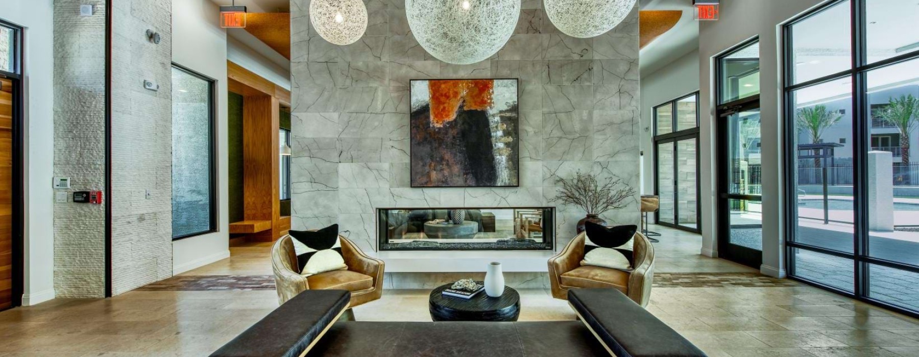 a room with a couch and a table with a large chandelier